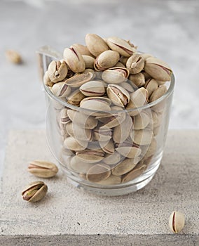 Pistachio in glass. Nuts. Green fresh pistachios as texture. Roasted salted pistachio nuts healthy delicious food studio photo. photo