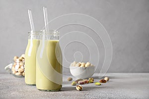 Pistachio milk in glass, lactose free. Non dairy. Vegan nutty plant based milk.