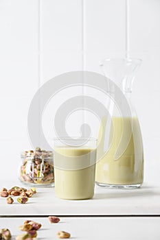 Pistachio milk in glass, lactose free. Vegan nutty plant based milk.