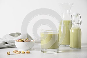 Pistachio milk in glass, lactose free. Vegan nutty plant based milk.