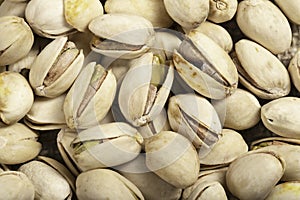 Pistachio nuts arranged on a burlap cloth. A tasty snack consumed with beer