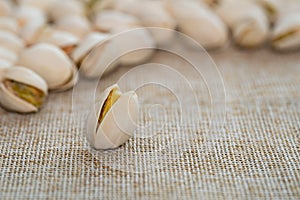 Pistachio nuts on brown sack background. Healthy food high protein