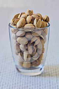 Pistachio nuts in a jar on a white background