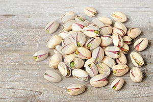 Pistachio nuts with shell on the wooden board