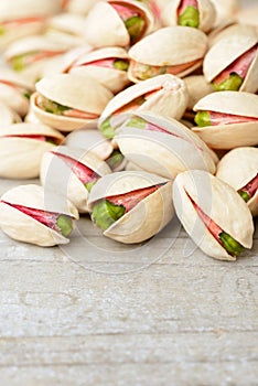 Pistachio nuts with shell on the wooden board