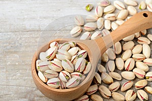 Pistachio nuts with shell on the wooden board