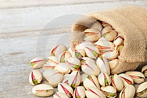 Pistachio nuts with shell on the wooden board