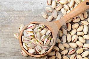 Pistachio nuts with shell on the wooden board, top view