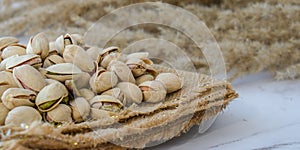 Pistachios in burlap sack on concrete table. Organic pistachios. Vegan Healthy food high protein. Dietary nutrition