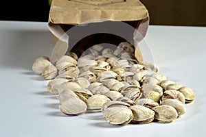 Pistachios coming out of a paper package