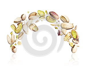 Pistachios crushed in the air on white background