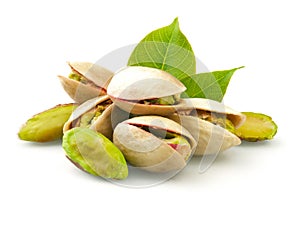 Pistachios with leaves on white background photo