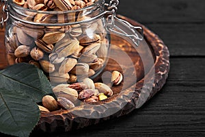 Pistachios nuts on dark background, top view, healthy snack