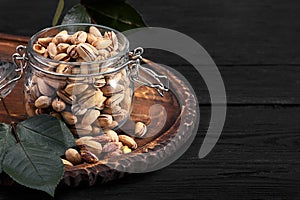 Pistachios nuts on dark background, top view, healthy snack