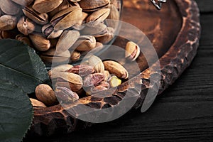 Pistachios nuts on dark background, top view, healthy snack