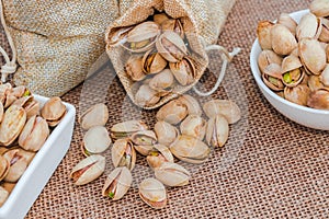 Pistachios in a sack and ceramic bowl
