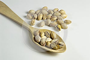 Pistachios on a wooden spoon