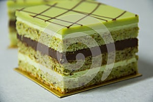 Pistacho layer cake and chocolate garnache photo