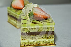 Pistacho layer cake and chocolate garnache photo