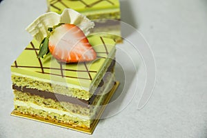 Pistacho layer cake and chocolate garnache photo