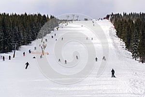 Piste with unrecognizable people skiing, snow, sunny winter day, Horni Mala Upa, Krkonose, Czech Republic