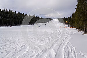 Piste with unrecognizable people skiing, snow, sunny winter day, Horni Mala Upa, Krkonose, Czech Republic