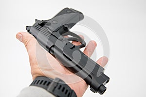 Image of a single gun/pistol in a man`s hand against a isolated white background