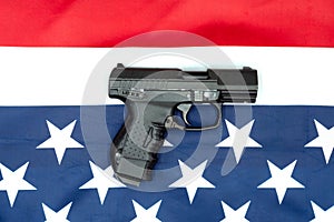 Pistol, american flag flat lay on gray background. United States Gun Laws - Guns and weapons