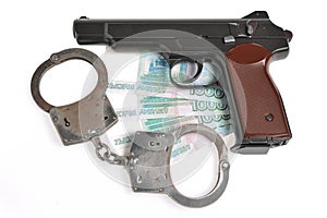 Pistol with handcuffs on money isolated