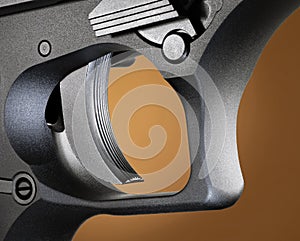 Pistol trigger on a beige background