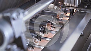 Pistons extruding cream for the production of marshmallows. Mechanism at the confectionery factory.