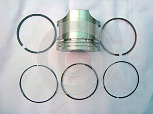 Pistons with motorcycle rings on a white background