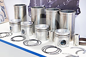 Pistons, sleeves and oil scraper rings on store