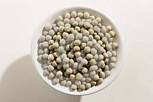 Pea. Top view of grains in a bowl. White background.