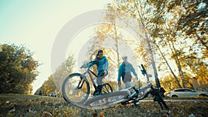 Pit stop on the bike trip in the autumn forest. Man repairing bicycle