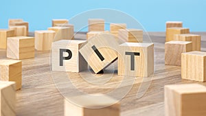 PIT written on wooden cube, business concept