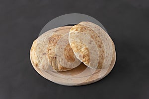 Pita bread on dark background. Arabic bread, traditional food