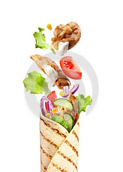 pita bread with flying vegetables and chicken on a white background