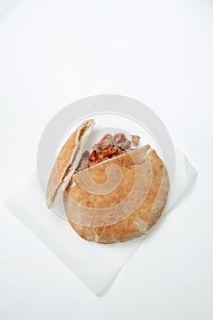 Pita bread sandwiches with grilled meat and vegetables on the light background. Closeup. Healthy fast food concept. Vertical