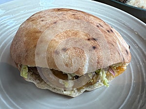 Detail of food in pita bread, it is a light and delicate bread, less dense, low in calories. photo