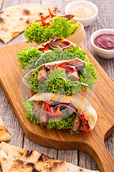 Pita with salad , paprika and beef meat . Traditional arabian and israel food