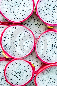 Pitahaya. Dragon fruit. pattern of tropical fruits cactus light light contrast background pink red skin with white flesh