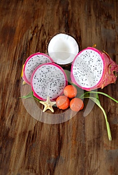 Pitahaya slices, papaya balls and a half of coconut