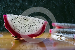a splash of water drips into the pitaya