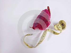 pitaya fruit or dragon fruit and measuring tape isolated on white background