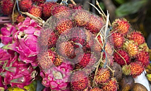 Pitaya and rambutan are lying on the counter. Indonesia.