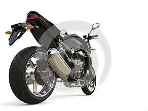 Pitch black modern sports motorcycle - rear wheel closeup shot