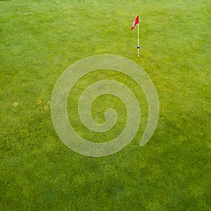 Pitch of a golf course with flag at a hole