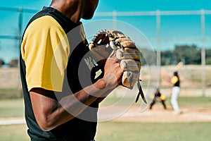 This pitch will make or break him. a young baseball player getting ready to pitch the ball during a game outdoors.