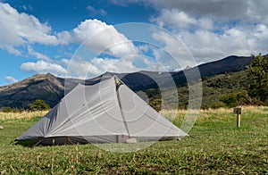 Pitched Tent with Mountains in background